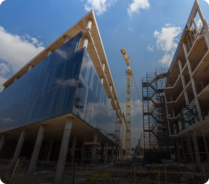 Modern building under construction with crane.
