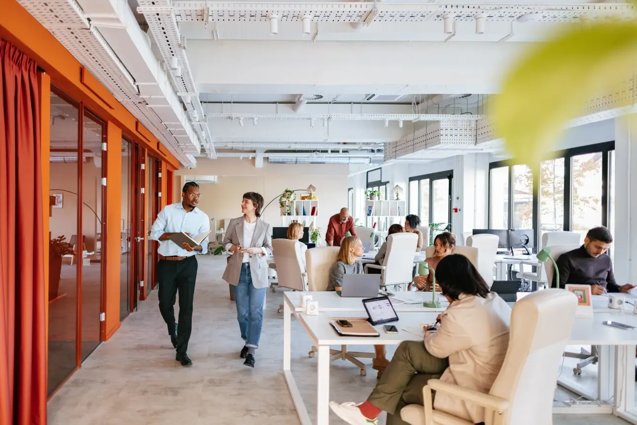 Open-plan office with people working and collaborating.