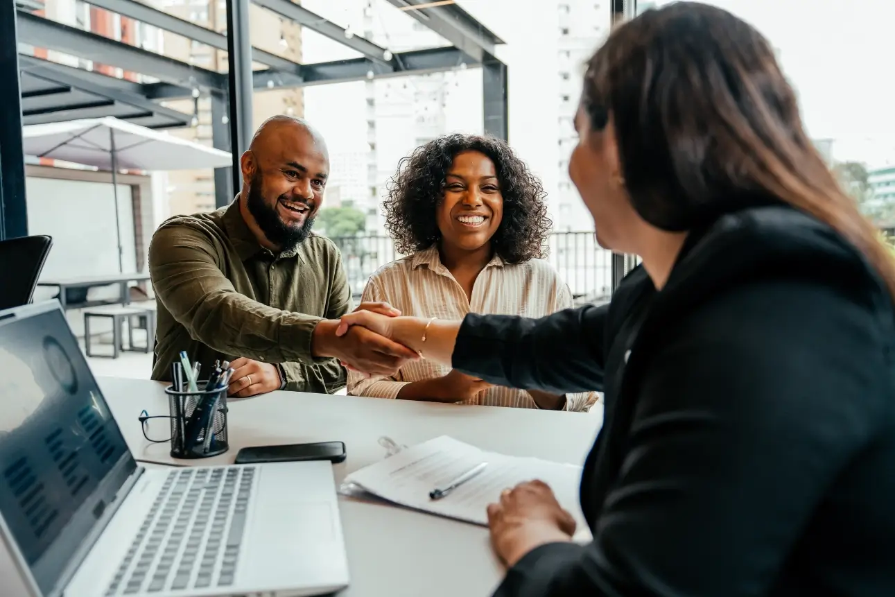 People shaking hands in a business meeting.