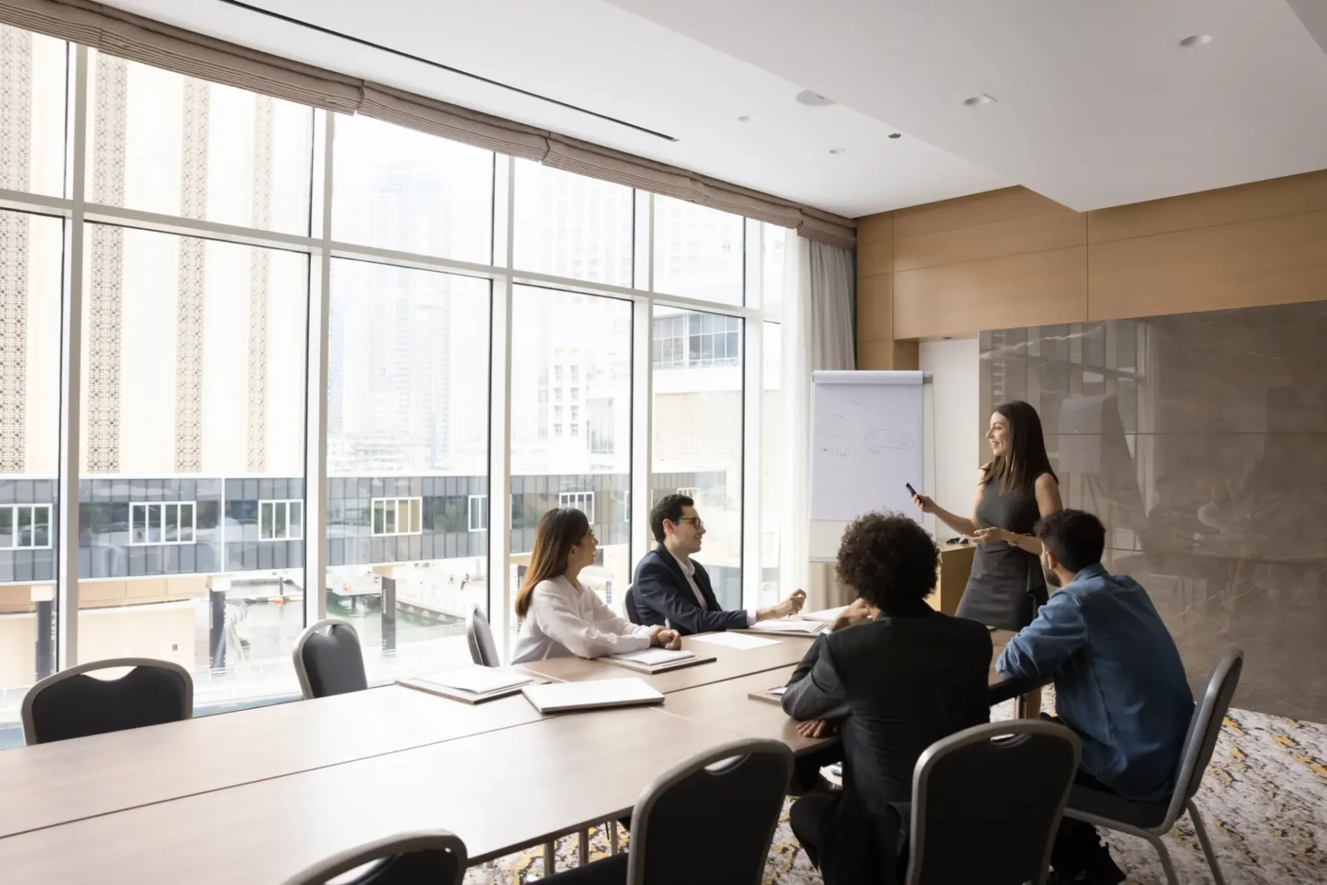Business meeting in a modern conference room with a presenter and attentive team.
